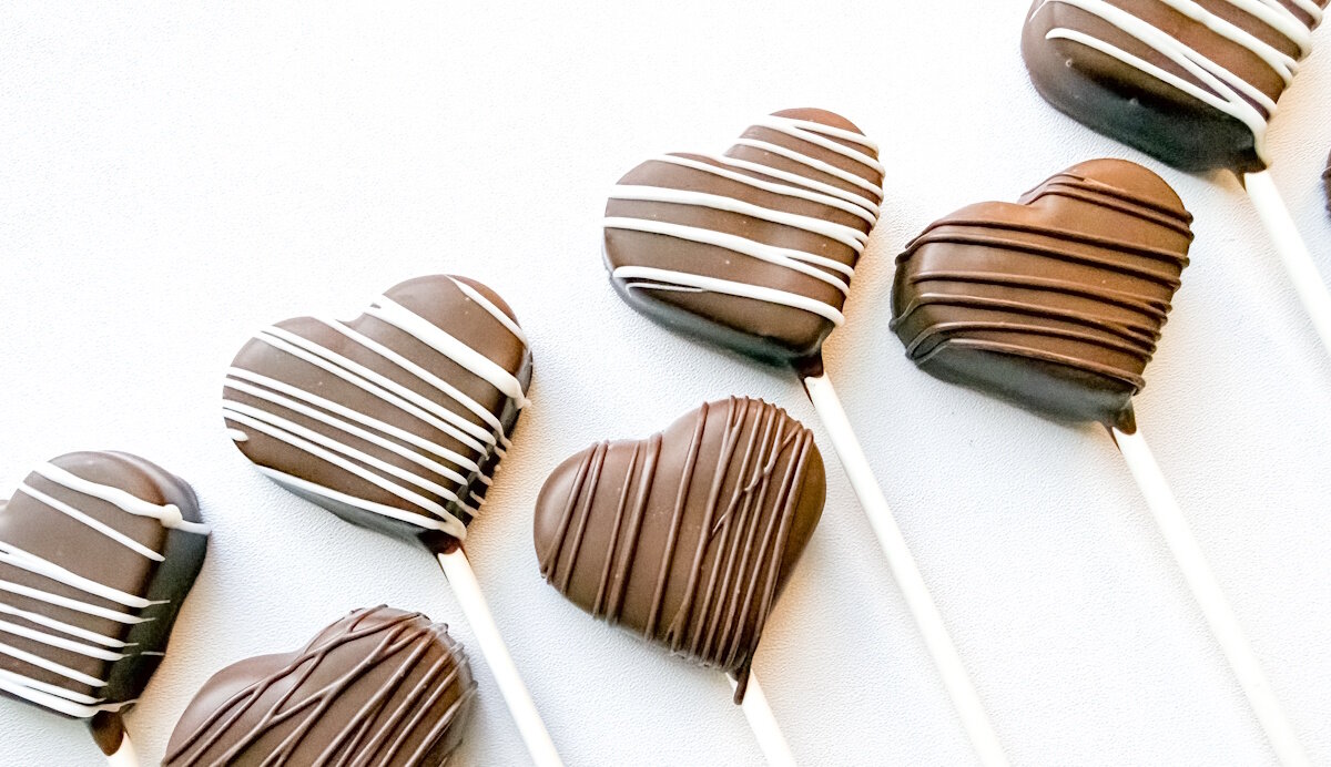 Chocolate-dipped heart cake pops with white and dark chocolate drizzle