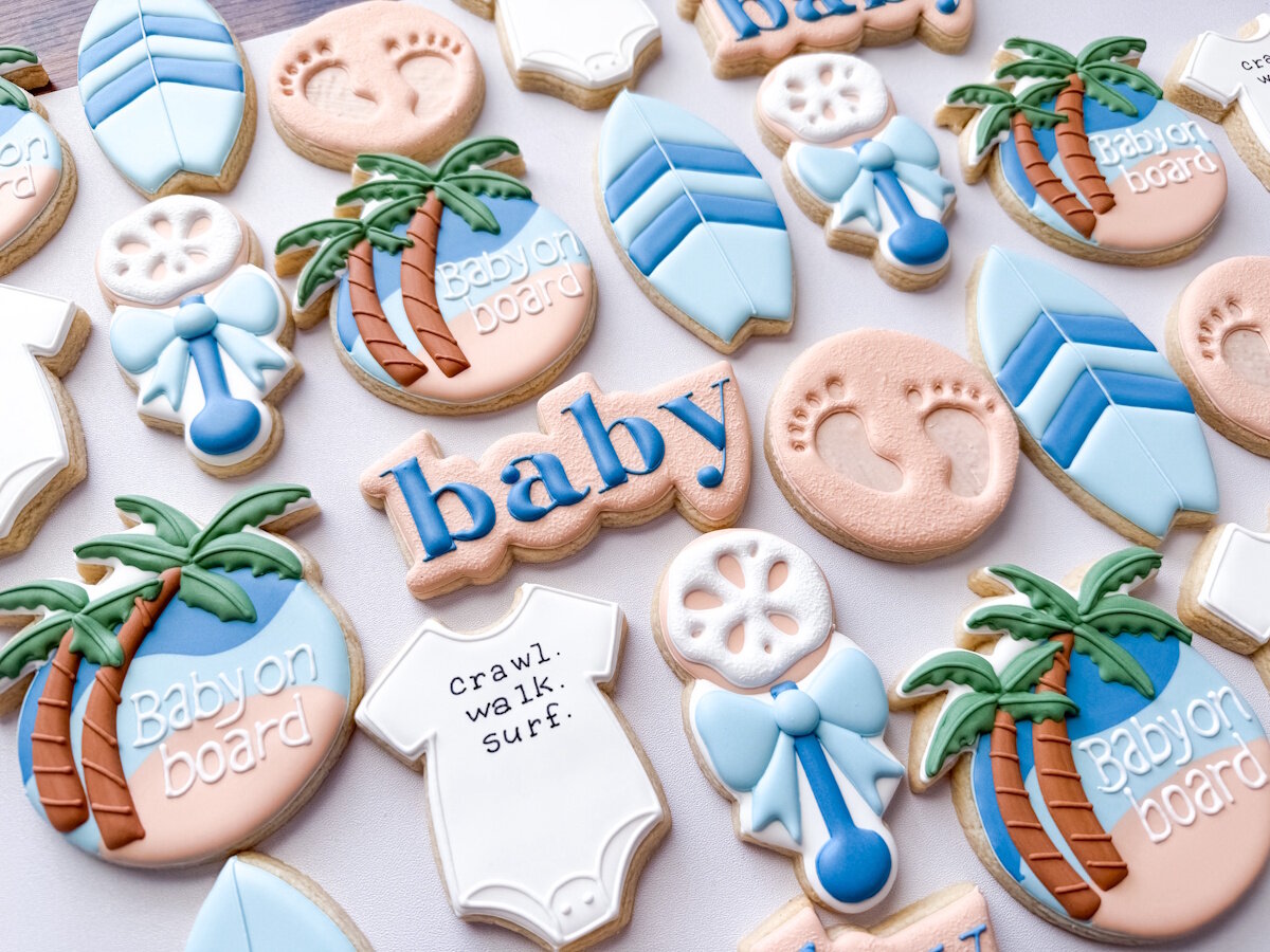 Baby on Board surf themed shower cookies with surfboards, palm trees, and sand dollars