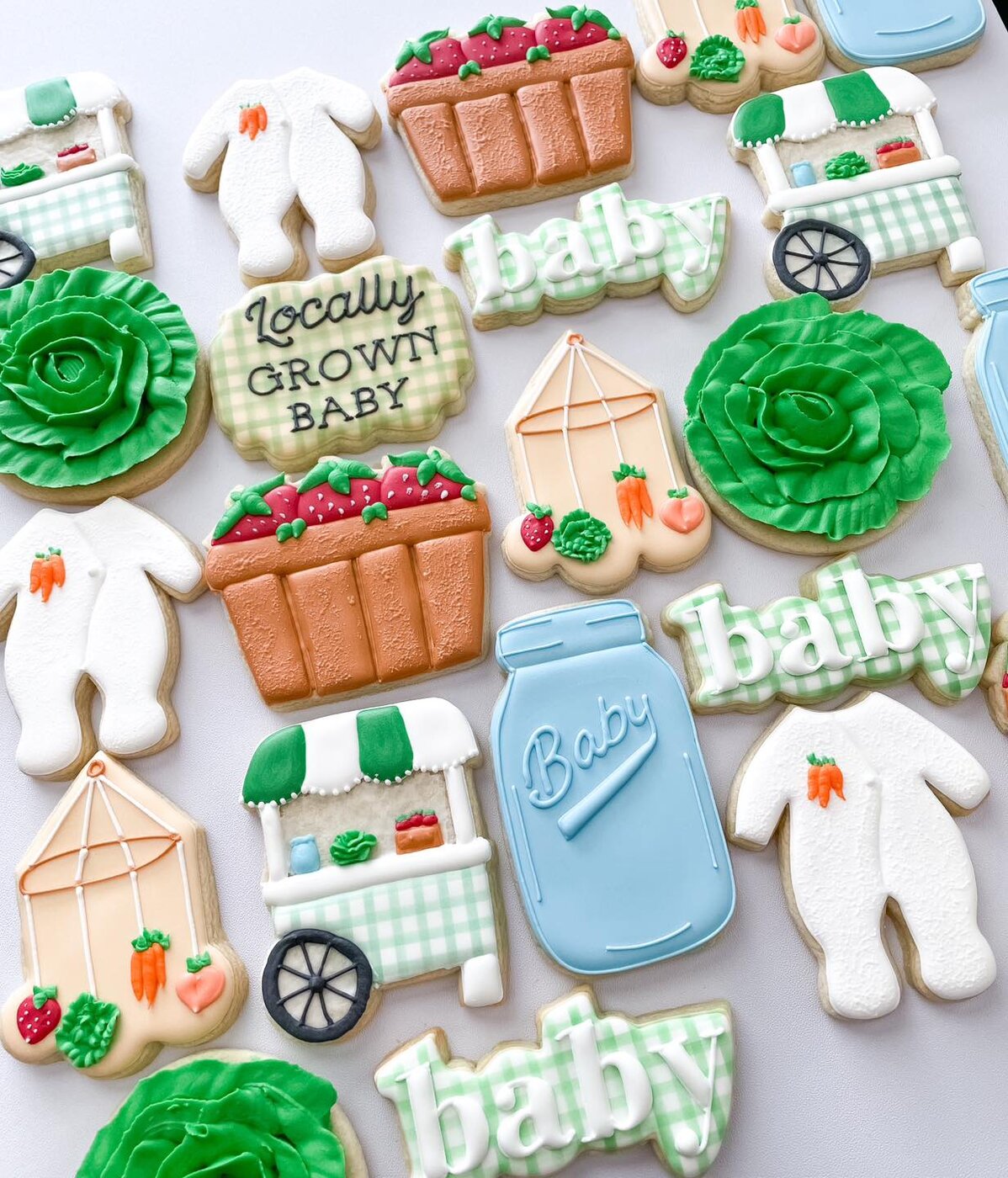 Farmers market baby shower cookies with produce carts, strawberry baskets, and gingham lettering
