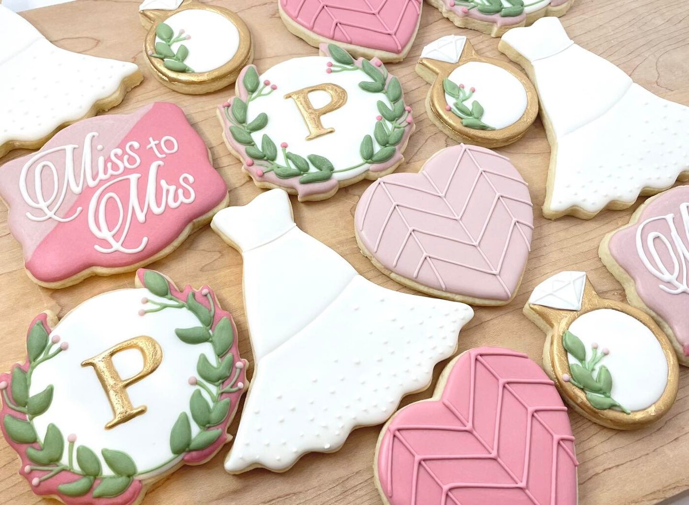 Miss to Mrs bridal shower cookies with wedding dresses, diamond rings, and gold monograms