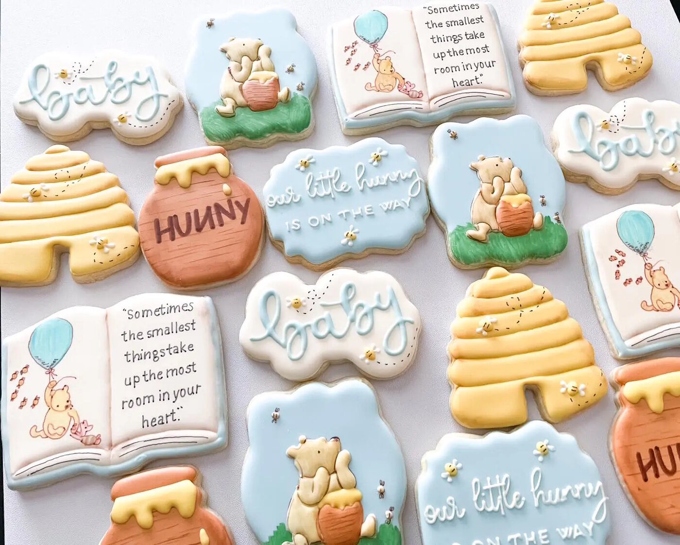 Classic Winnie the Pooh baby shower cookies with hunny pots, beehives, and storybook scenes