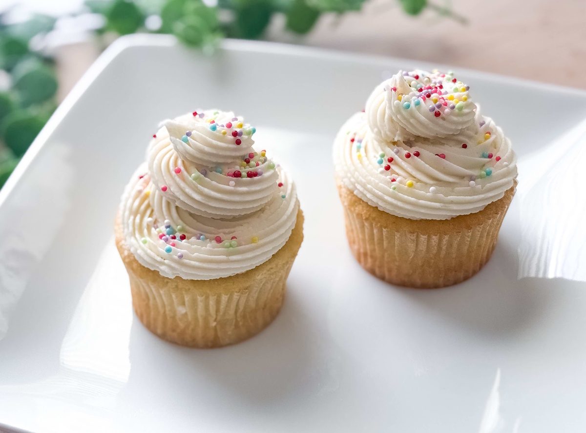 Classic vanilla cupcakes with buttercream swirl and rainbow sprinkles