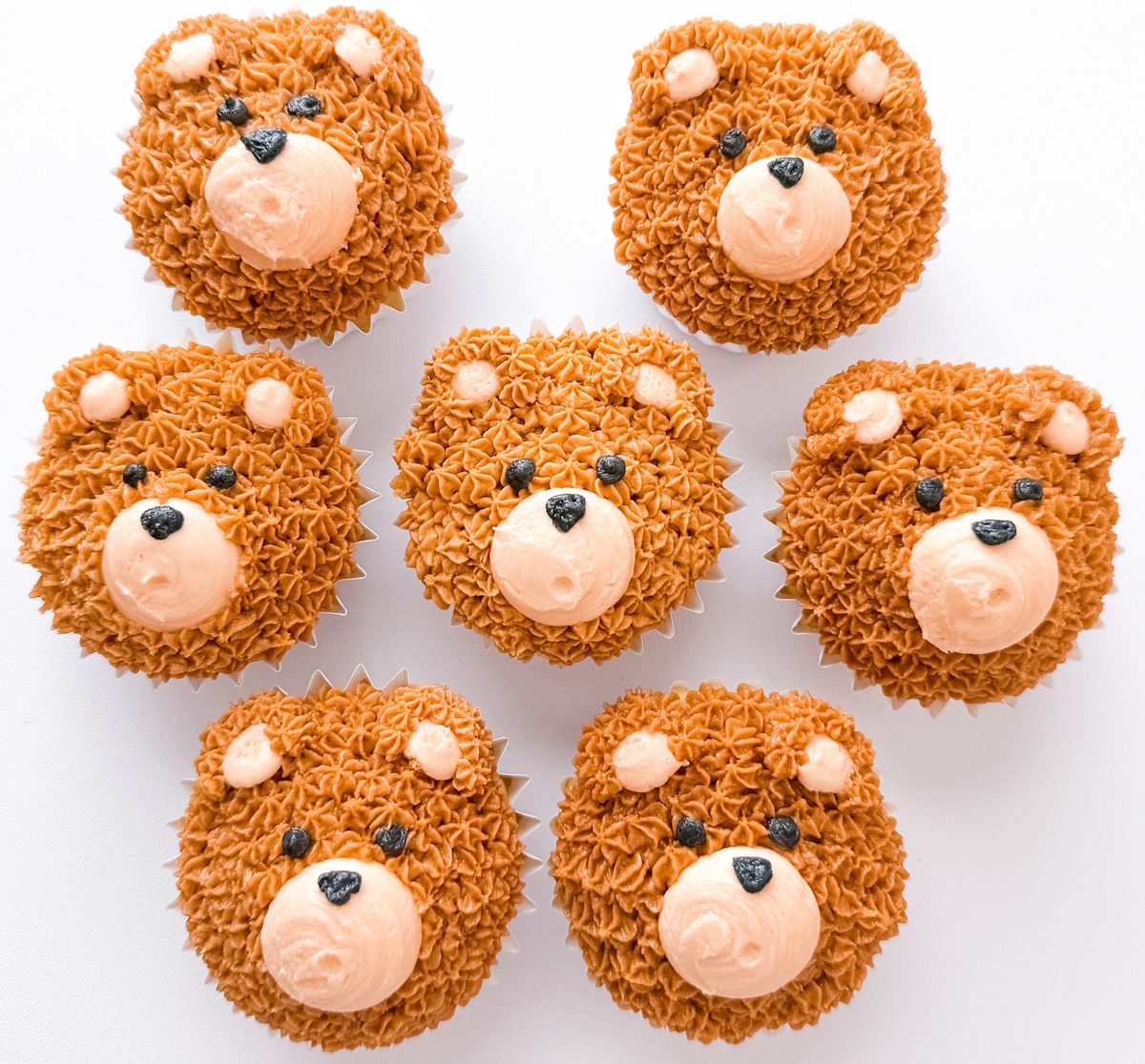 Teddy bear cupcakes with piped buttercream fur and cream muzzles